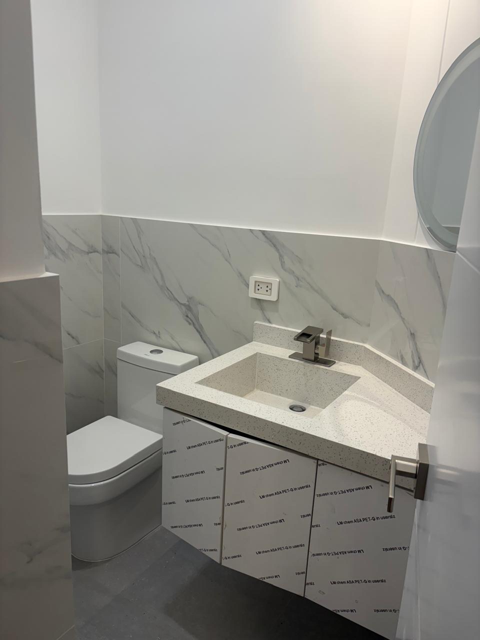 Bathroom — marble and round mirror